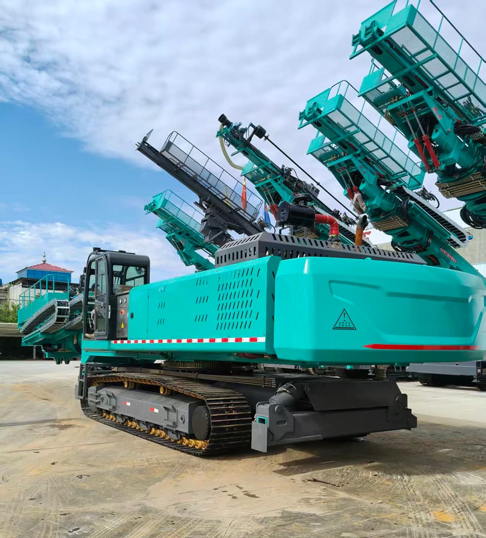 Large teal crawler slope drill photographed with elevated drilling structure